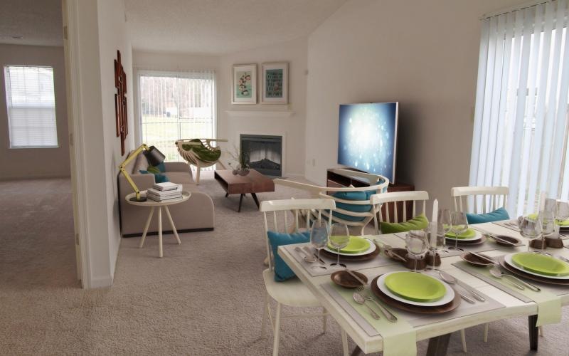 a living room with a table and chairs